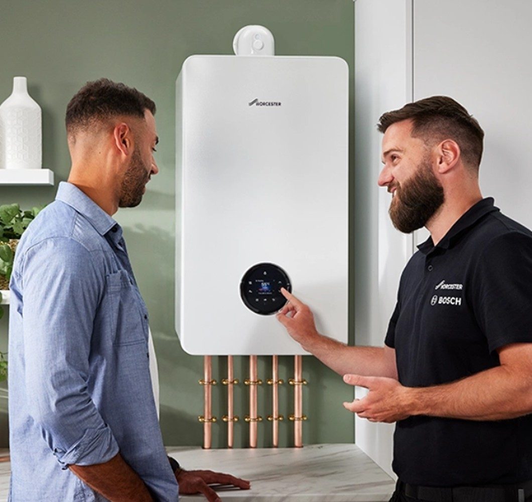 Heating engineer explaining boiler servicing and repairs to homeowner in Leeds