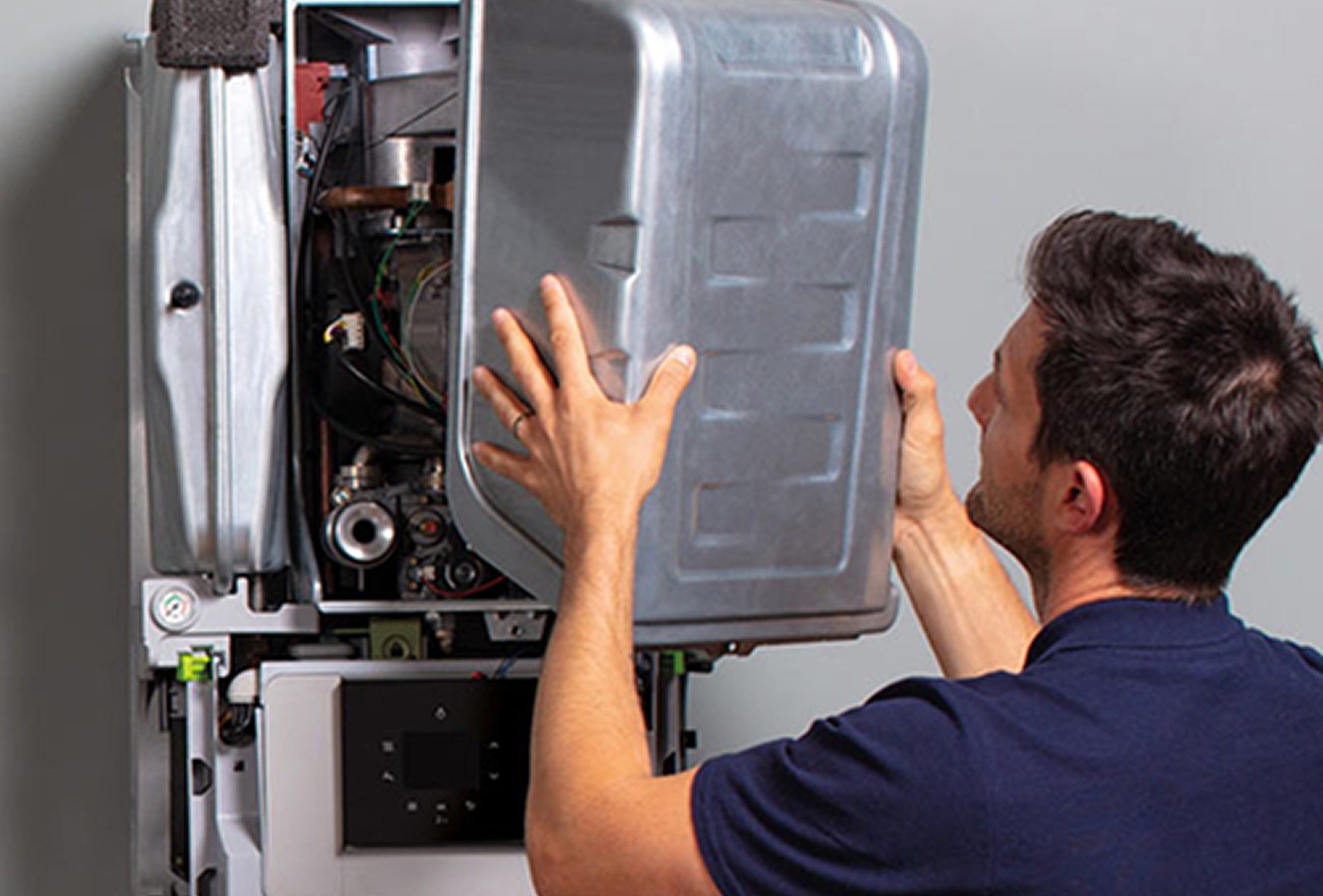 Gas Safe engineer repairing a boiler for plumbing and heating services in Leeds