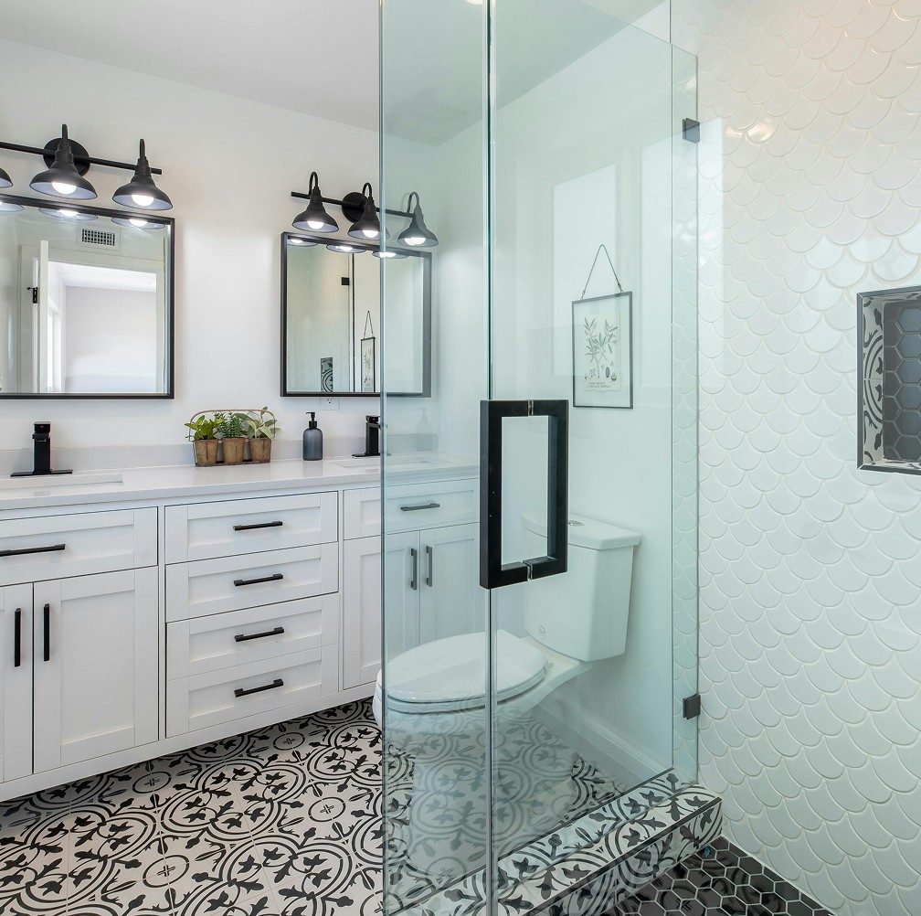 Stylish bathroom installation in Leeds with vanity unit, walk-in shower and decorative tiled flooring